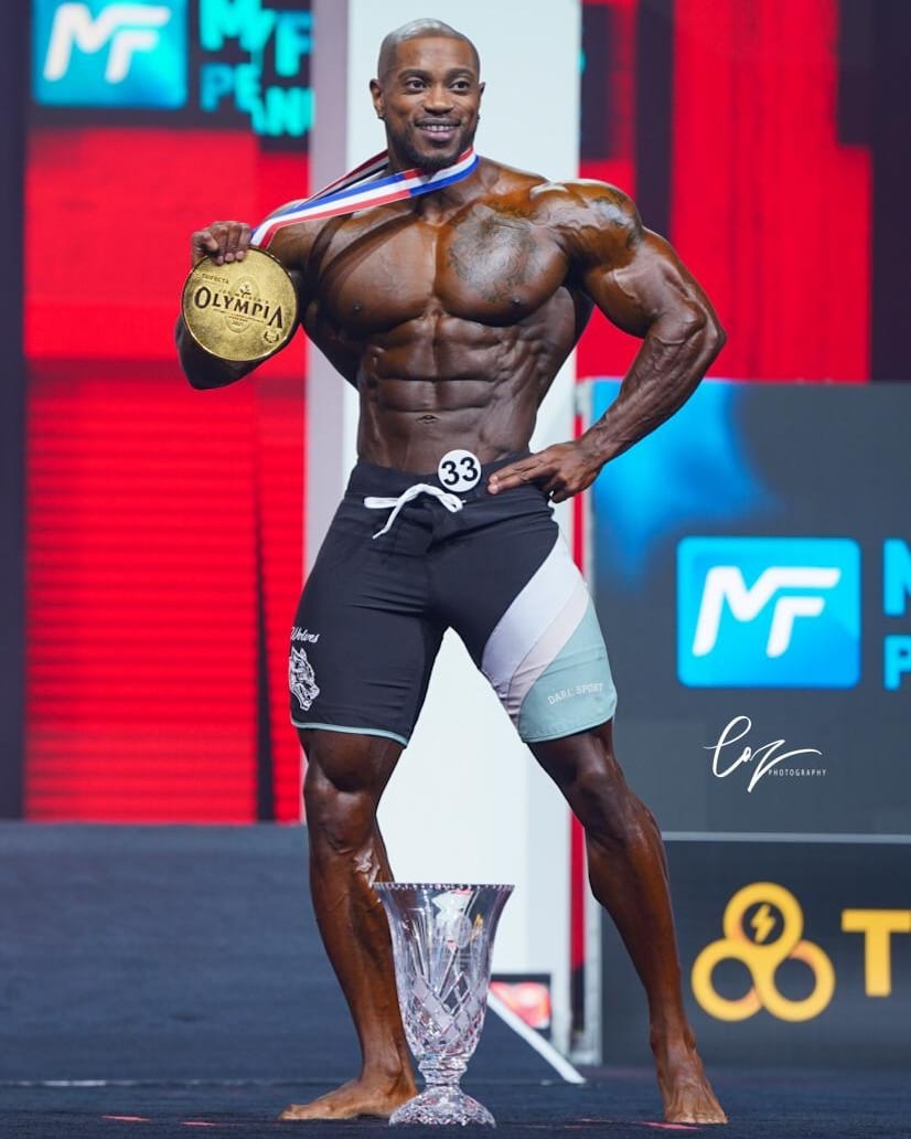 Brandon Hendrickson · Brandon Hendrickson posing with his gold medal at the 2021 Men’s Physique Olympia