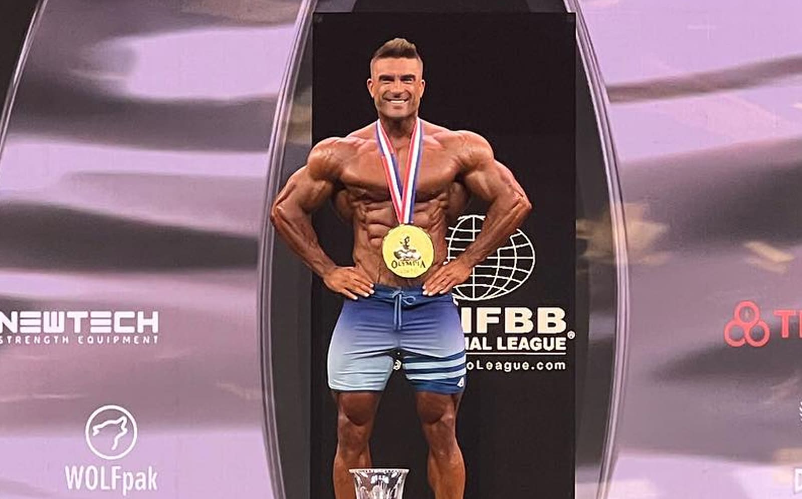 Ryan Terry · Ryan Terry posing with his trophy and gold medal at the 2023 Men’s Physique Olympia